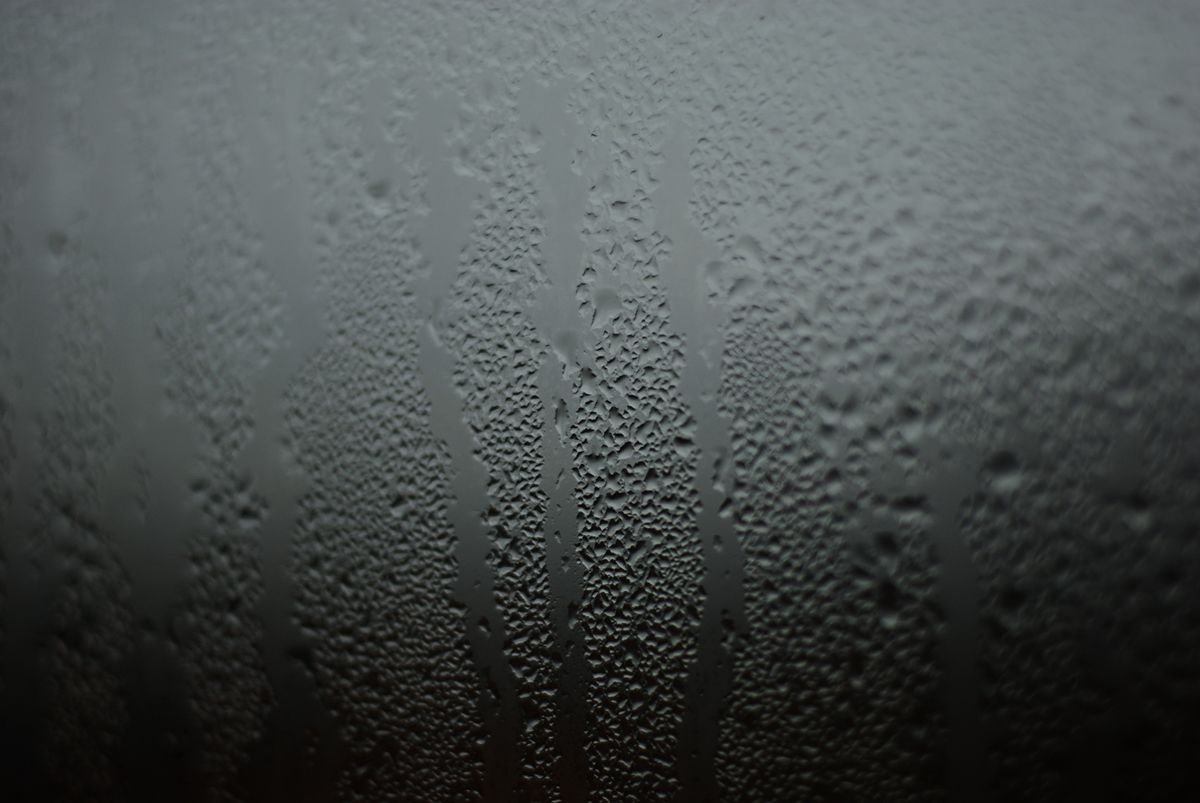 Condensation forming on a glass surface, illustrating water vapour in the air rather than liquid water in the substrate