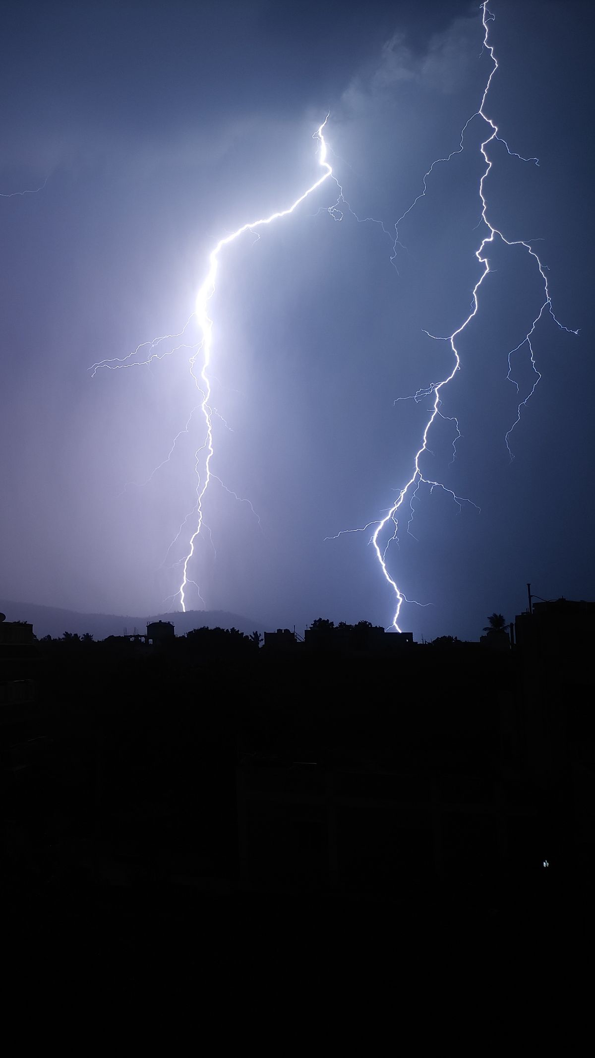 Intense lightning bolts illuminating the night sky during a powerful storm