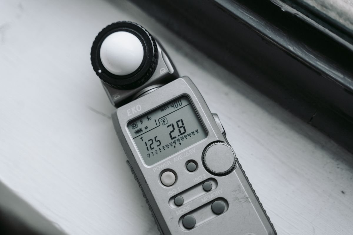 A light meter positioned on a windowsill to measure light intensity